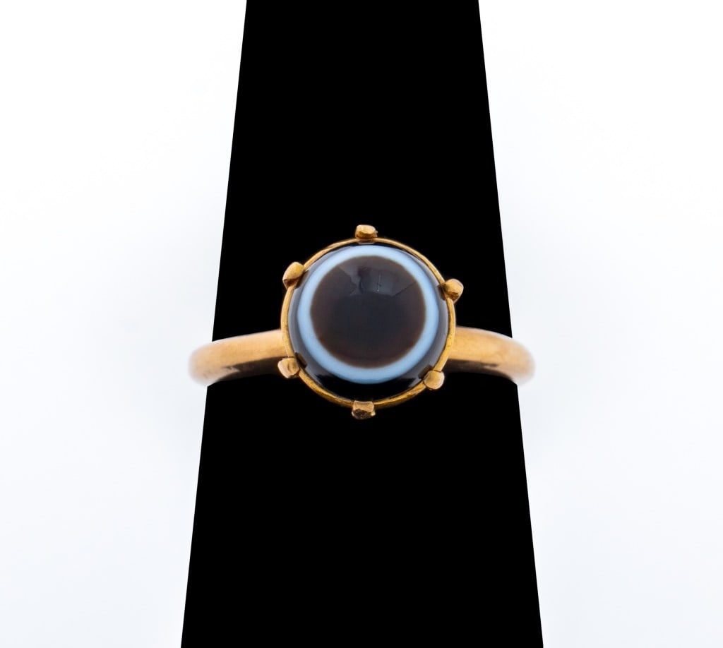 Victorian 14K Yellow Gold Agate Ring: Victorian Period 14K Yellow Gold Agate Ring, crafted in brightly polished 14K yellow gold, featuring a banded agate cabochon. set in a bezel and prong mounting, approx. 7 mm. Gold tested. Measuring US
