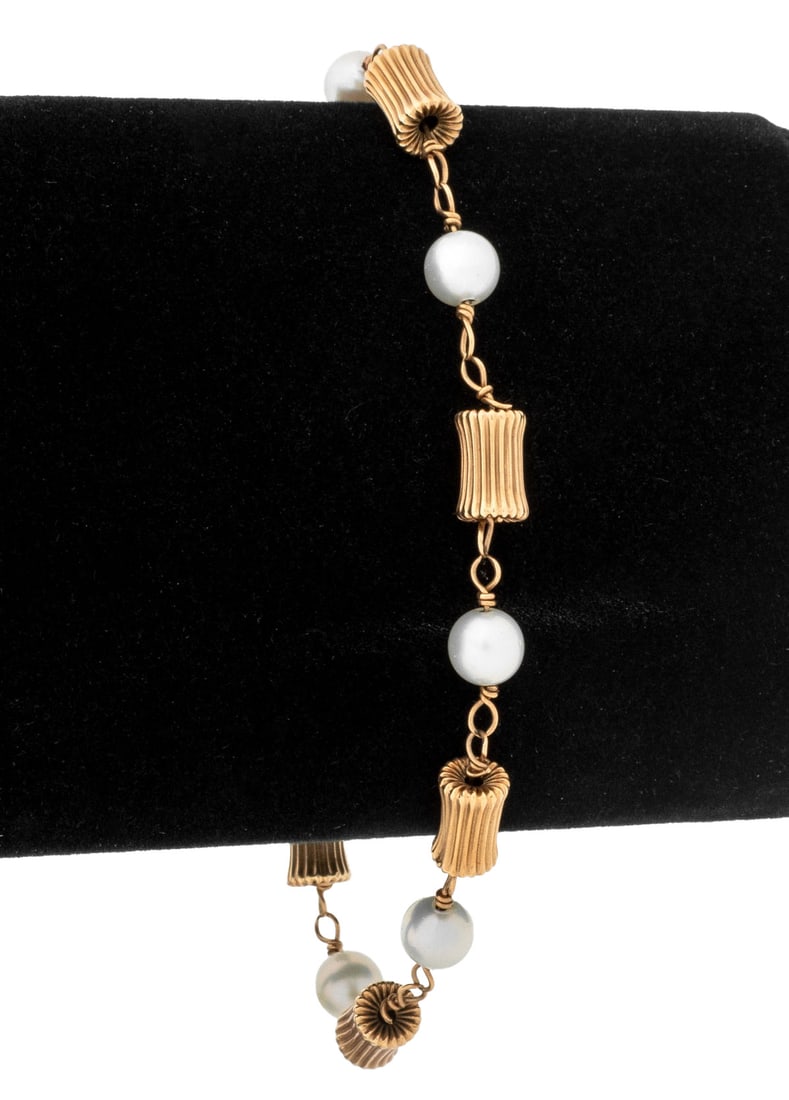 14K Yellow Gold Pearl Bracelet: 14K Yellow Gold Bracelet, adorned with 7 round cultured pearls, approx. 6.5 - 7.0 mm, joined with spring ring clasp, marked: "14K". Measuring approx. 7 3/4", 3.3 dwt. Provenance: From an Upper East Si