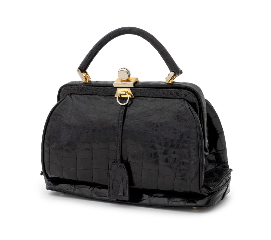 Lana Marks Black Alligator Handbag: Lana Marks Black Alligator Handbag, with single handle, gold-tone metal hardware, and "Lana Marks / Made in Italy" plaque label inside. To top handle: 9" H x 10" W x 4.5" D. Provenance: Property from