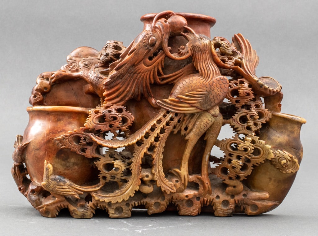 Chinese Carved Soapstone Vase Grouping: Chinese Carved Soapstone Vase Grouping, three vases surrounded by intricately carved phoenix and dragon in the clouds chasing a pearl, deep russet color with some attractive variation. 9" H x 12" W x