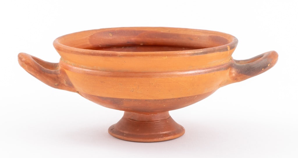 Ancient Greek Pottery Kylix: Ancient Greek Pottery Kylix, circa late 6th century BCE, with a band of red around body and handles. 2.5" H x 6.25" W x 4.5" D. Provenance: From a New York City Collection. Keywords: Greece,