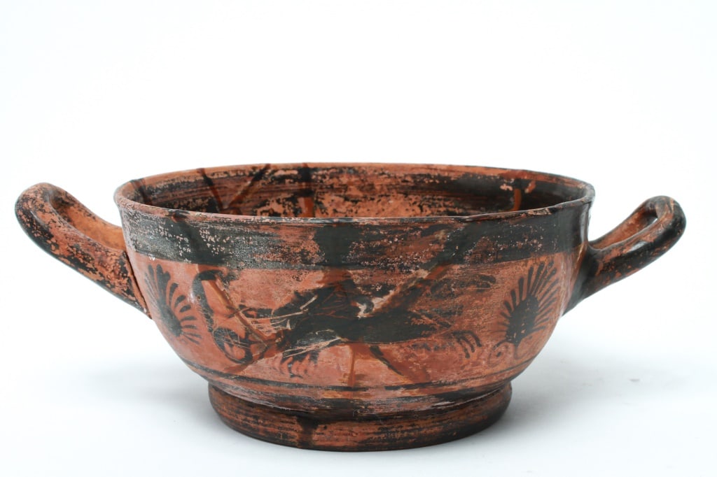 Greek Hand-Painted Terracotta Two Handled Bowl: Greek Hand-Painted Terracotta Two Handled Bowl, depicting a chariot with horses and acanthus leaf motif on either side. 4" H x 11.25" W (over handles). Provenance: From a New York City Collection.