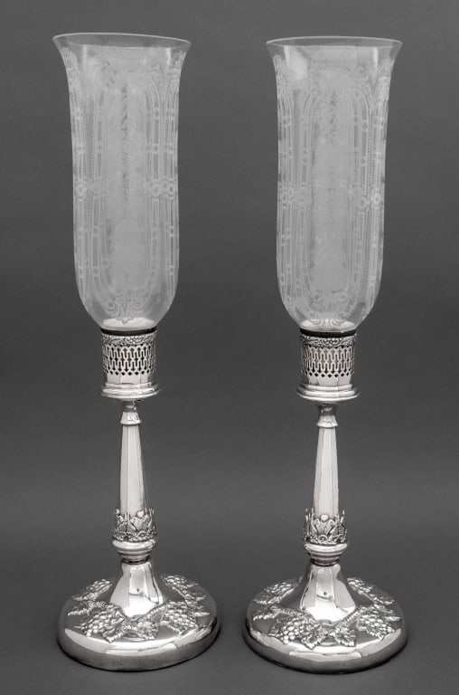 Lawrence B. Smith Co. Silver Plate Storm Lamps, 2: Pair of Lawrence B. Smith Co. Silver Plate Storm Lamps, 20th century, with grapevine motif to base and etched floral glass shades, faded mark to the bases. 20" H x 5.75" Diameter. Provenance: From a P