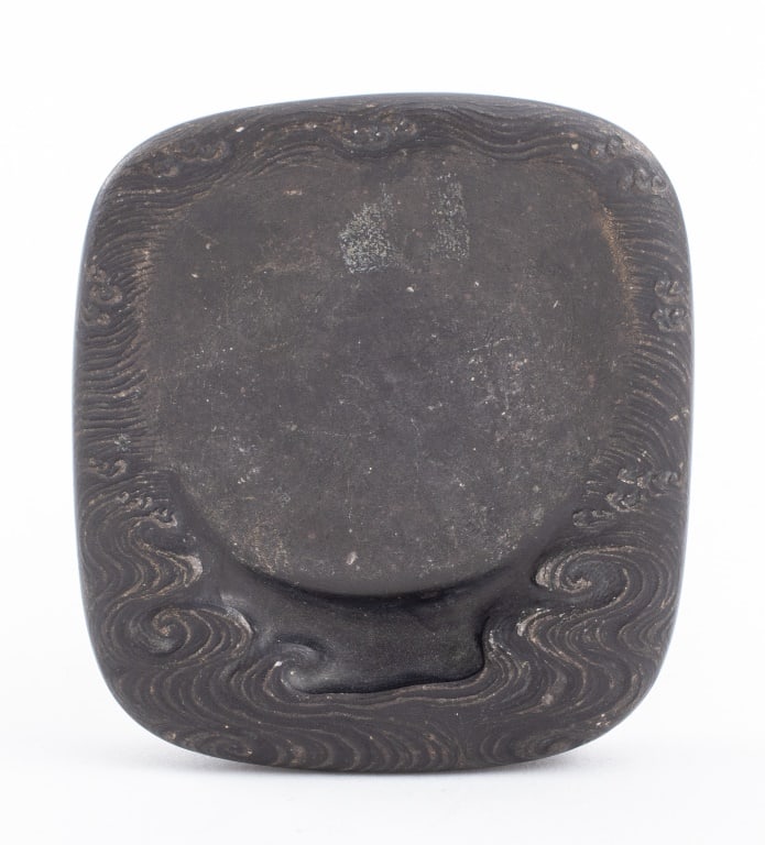 Chinese Cloud Motif Inkstone: Chinese Cloud or Wave Motif Inkstone. 3" H x 2.75" W x 0.5" D. Provenance: Property from the Manhattan estate of Indrani Yogasundram, who lived in many different countries with her husband Yogaraj