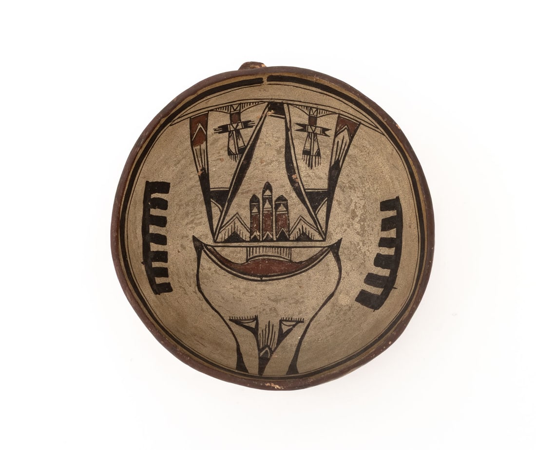 Hopi Polychrome Pottery Bowl, 19th C.: Hopi Polychromed Pottery Bowl, 19th century, with geometric red and black design to the interior and a notch for a handle at the top, possible pictorial mark, handwritten "LS", and "22" label to under