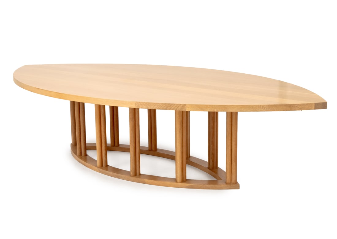 Contemporary Pointed Oval Blonde Wood Dining Table: Contemporary Pointed Oval Blonde Wood Dining Table, the top above ten cylindrical supports mounted on pointed oval base. 29" H x 125.5" W x 65.5" D. Provenance: From a 28 East 70th Street Penthouse Es