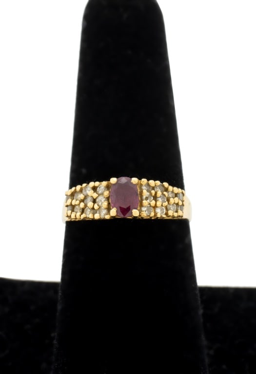 14K Yellow Gold Ruby and Diamond Cluster Ring: 14K Yellow Gold Ruby and Diamond Cluster Ring, adorned with one ruby weighing approx. 0.40 carat and twenty diamonds weighing approx. 0.20 carat, marked: "14K". U.S. ring size 8 1/4; 3/4" x 1.0";