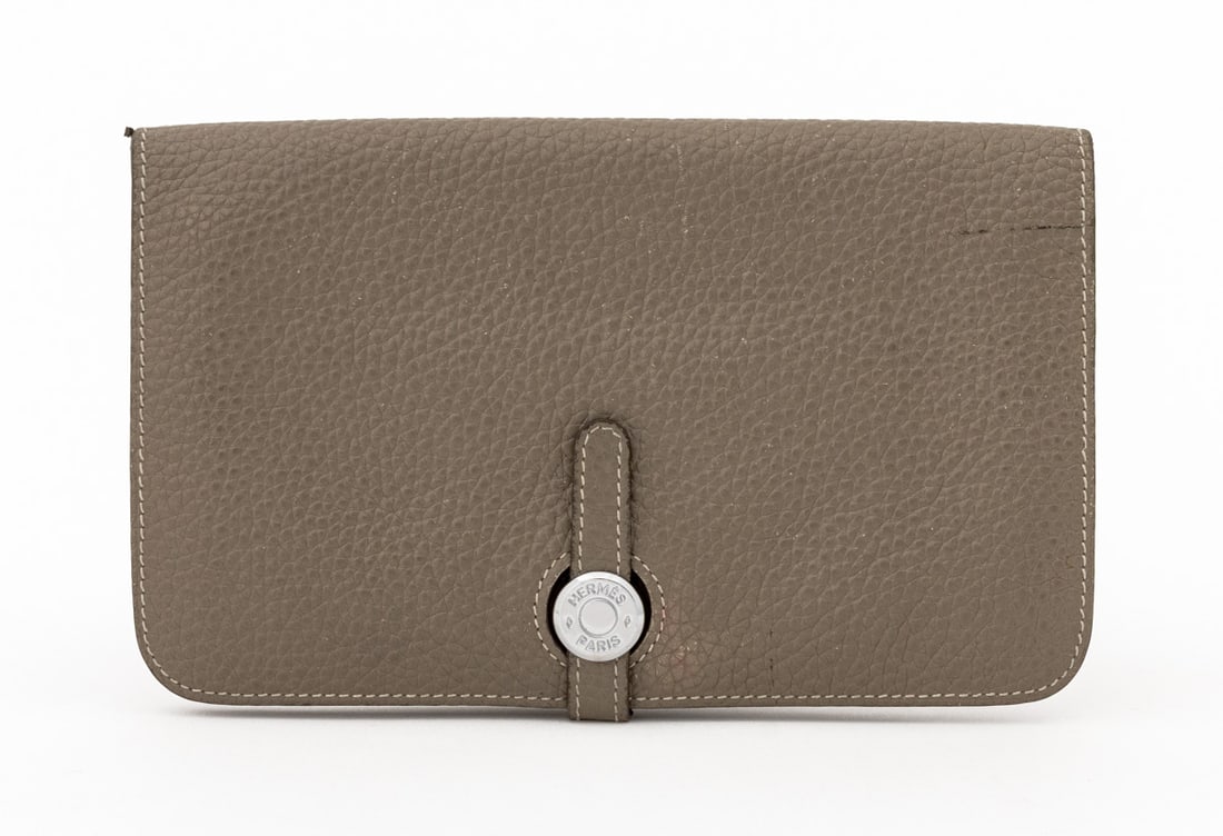 Hermes Dogon Gray Leather Wallet: Hermes Dogon Gray Leather Wallet, with palladium hardware, with divided interior and three slip pouches, marked "Hermes / Paris / Made in France". 7.75" L x 5." W. Provenance: From a New York City Col