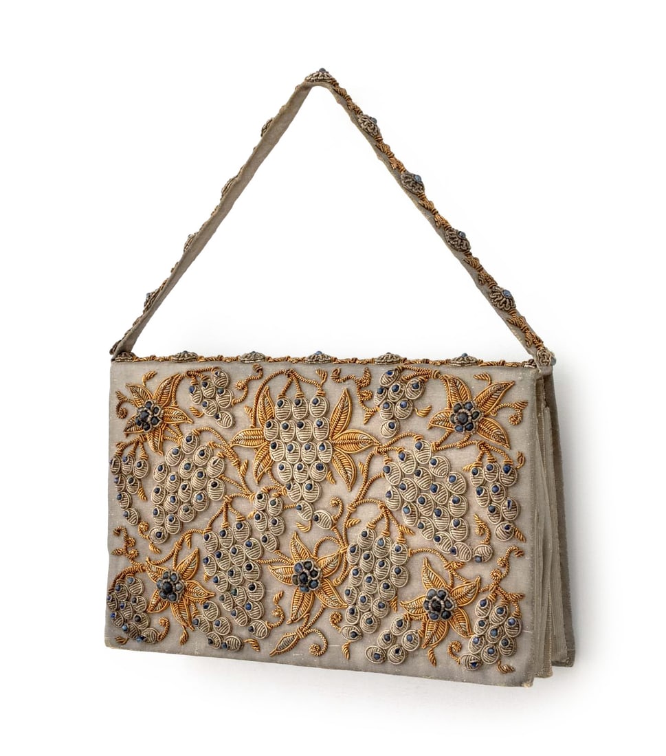 Indian Sapphire & Vermeil Encrusted Silk Handbag: Indian Sapphire and Vermeil Encrusted Silk Handbag, with embroidered grape bunches and flowers, "Ivory Palace / Delhi (India)" label inside. 5.5" H x 9 W x 2" D. Provenance: From a Greenwich, Connecti