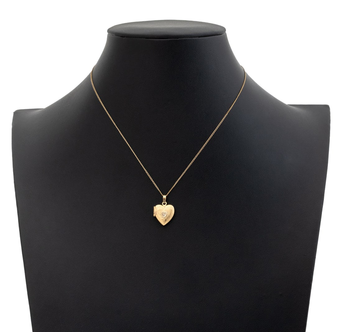 14K Yellow Gold Diamond Heart Locket Necklace: 14K Yellow Gold Diamond Heart Locket Pendant Necklace, featuring one detachable heart shaped locket pendant adorned with one bead set single cut diamond weighing approx. 0.005 carat, worn with link