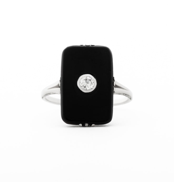 Art Deco 14K White Gold Onyx Diamond Ring: Art Deco 14K White Gold Onyx Diamond Ring, featuring one prong set black onyx tablet approx. 15 x 10 mm, adorned with one bezel set round faceted diamond weighing approx. 0.08 carat. Gold tested.
