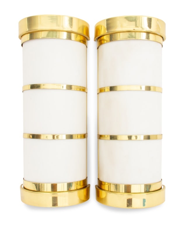 Brass Mounted Acrylic Shade Wall Sconces, Pair: Pair of Cylindrical Brass Mounted Acrylic Shade Flush Mount Wall Sconces, each in frosted acrylic with brass banding to top and bottom. 19.5" H x 7.75" W x 4.5" D. Provenance: From a New York City