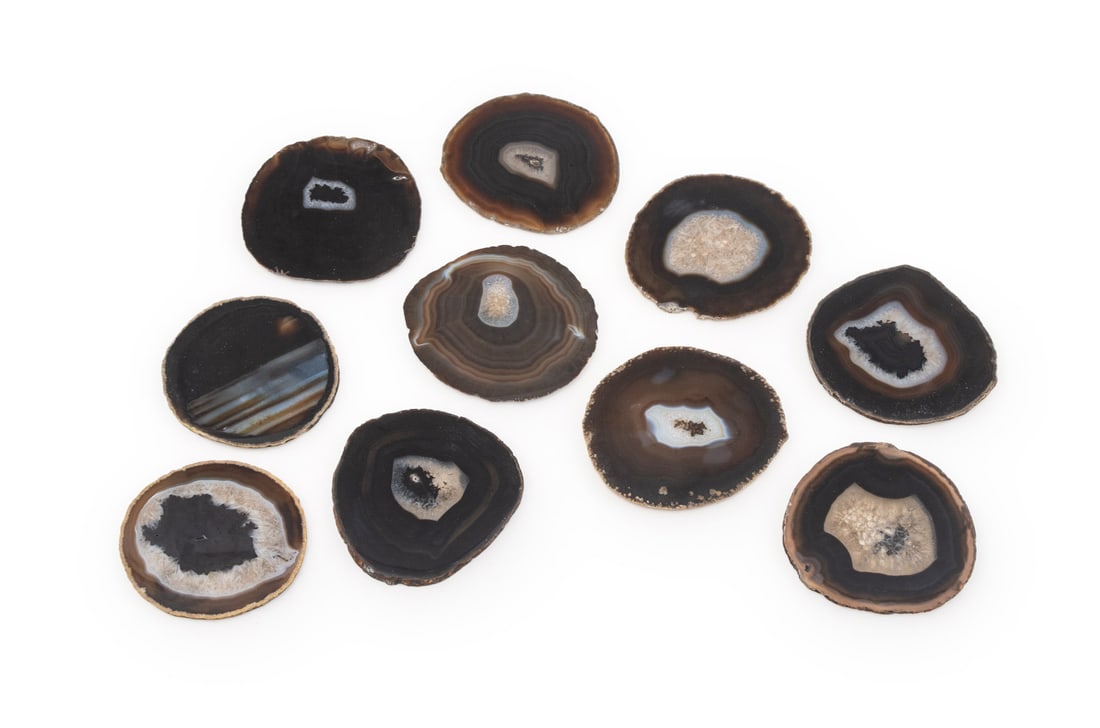 Banded Agate Coasters, 10: Set of Ten Banded Agate Coasters, felt pads adhered to undersides. Each: 4.75" L x 4.5" W x 0.25" H. Provenance: From an East 53rd Street Collection. Keywords: Tableware, Mineral Specimens, Crystals,