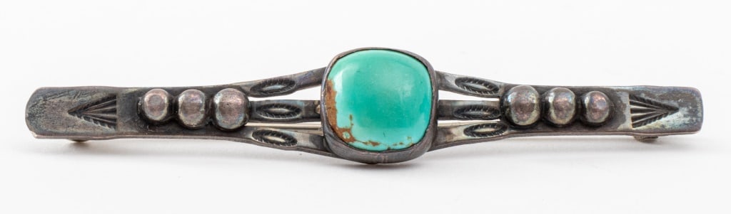 Navajo Dine Silver Turquoise Bar Pin: Navajo Dine Silver Turquoise Bar Pin, with one bezel-set 10 x 9 mm cushion cabochon-cut turquoise stone. Pin: 2.5" L x 0.43" W x 0.375" H. Silver tested. Approx: 0.19 ozt. inclusive. Provenance: Prope