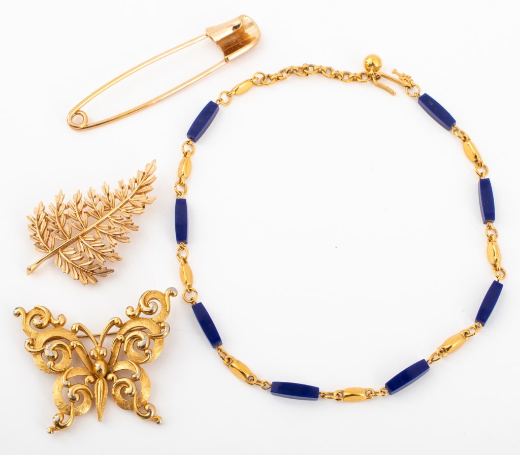 Trifari Gold-Tone Metal Jewelry, 4 Pieces: Group of Four Pieces of Trifari Gold-Tone Metal Jewelry, each marked and comprising: a foliate-form brooch, butterfly-form pin, paperclip-form pin, and a lapis lazuli choker necklace. Necklace: 15.25"