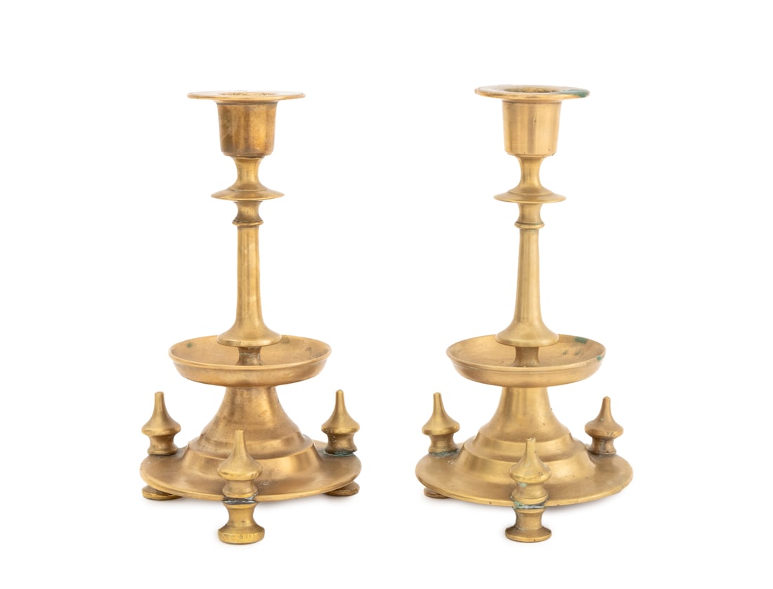 Russian Empire Brass Candlesticks, 19th C., Pair: Pair of Russian Empire Brass Candlesticks, late 19th century, of turned forms with circular drip pans and each atop three feet. 7.25" H x 3.75" Diameter. Provenance: From the Collection of Laura and L