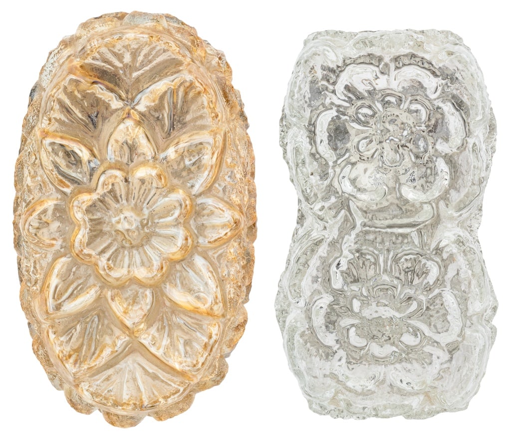 Floral Motif Art Glass Wall Sconces, 2: Two Floral Motif Art Glass Wall Sconces, one in clear glass and one amber glass, both flush mounted with brass plates. Larger: 9" H x 5.25" W x 4" D. Provenance: From a New York City Collection. Keywo