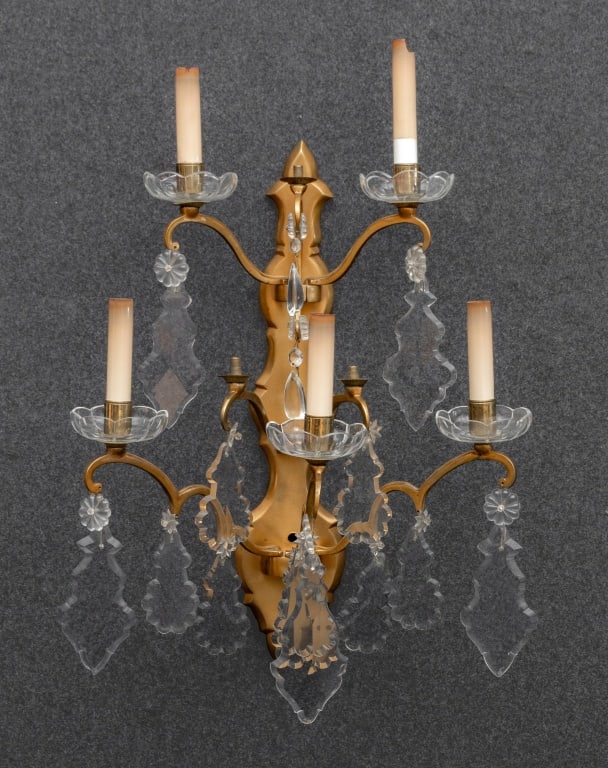 Regency Style Brass Five-Light Wall Sconce: Regency Style Brass Five-Light Wall Sconce, with scroll arms and drop prism crystal pendants. 24.75" H x 22.5" W x 11.5" D. Provenance: From a New York City Collection. Keywords: Applique, Lighting,