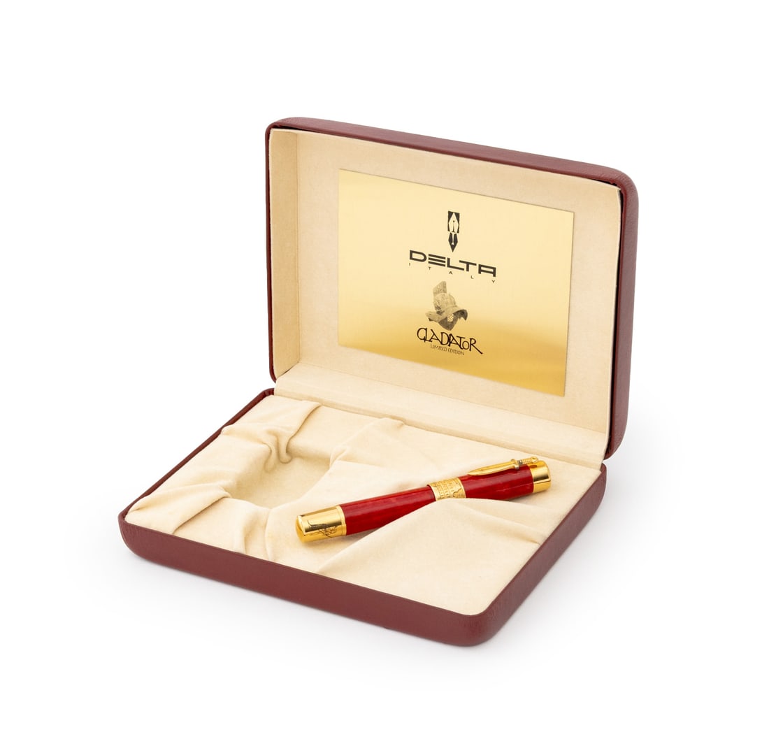 Delta Limited Edition Gladiator Fountain Pen: Delta Limited Edition Gladiator Fountain Pen, with 18K yellow gold nib, red resin case with gold-plated clip and accents, numbered edition "056/100", the red leather fitted case with engraved brass pl