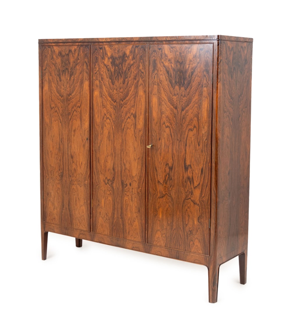 C.B. Hansen Rosewood Armoire: C.B. Hansen Rosewood Armoire, with two door cabinet opening to five shelves and single door cabinet on the left with four shelves on four tapered legs, "C.B. Hansen" plaque to reverse. 65" H x 58" W x