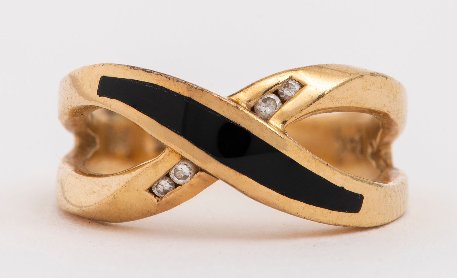 14K Yellow Gold Onyx Inlay & Diamond "X" Ring: 14K Yellow Gold Onyx Inlay and Diamond "X" Ring, channel-set with four round brilliant cut diamonds; approx: 0.06 carat total. Marked: "14K / HL". Ring measures: 0.87" L x 0.37" W at widest section.