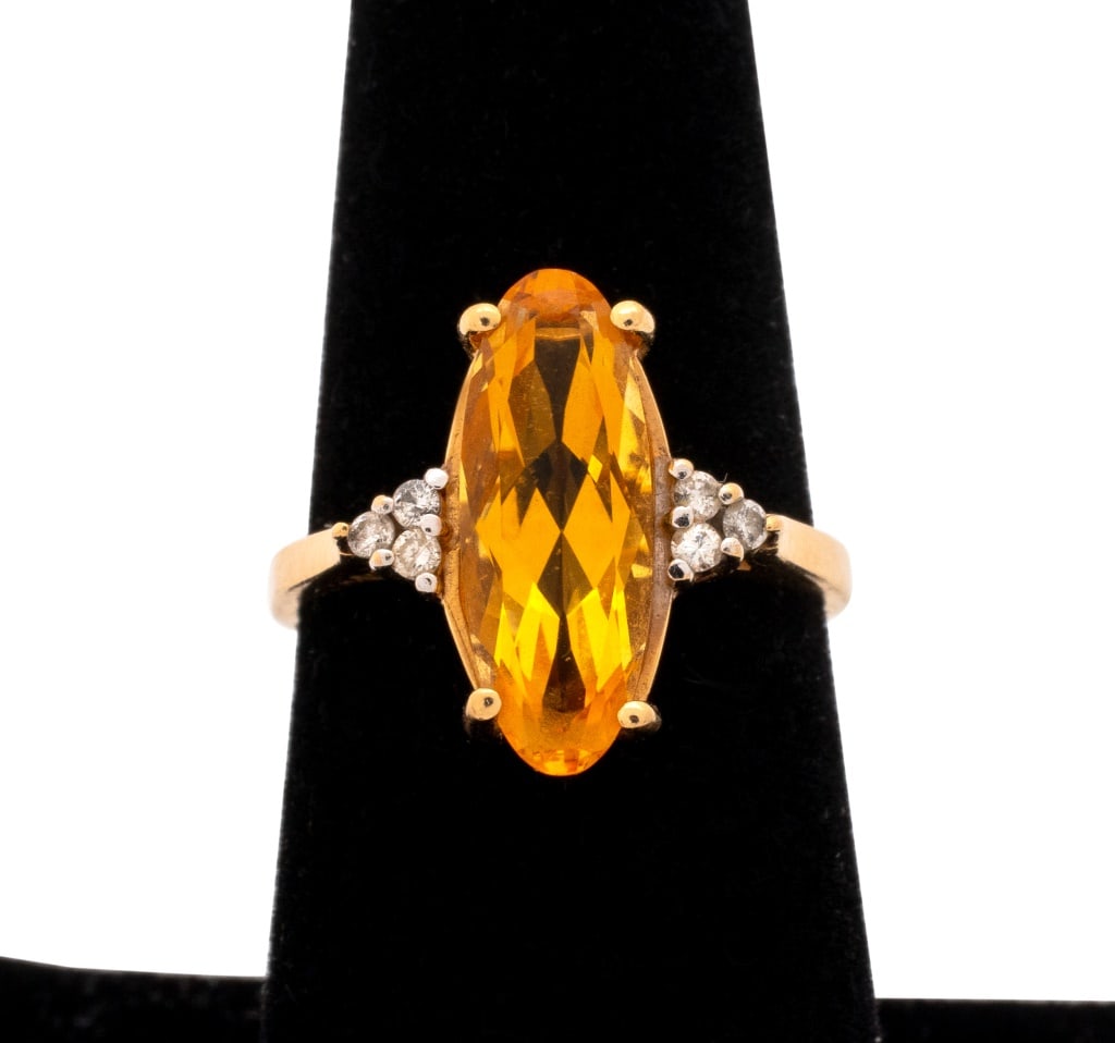 14K Yellow Gold Orange Tourmaline and Diamond Ring: 14K Yellow Gold Orange Golden Tourmaline and Diamond Cluster Ring, adorned with one tourmaline measuring approx. 2.5 carats and six diamonds weighing approx 0.10 carat, marked: "C10 14K". 1.0" x 3/4";