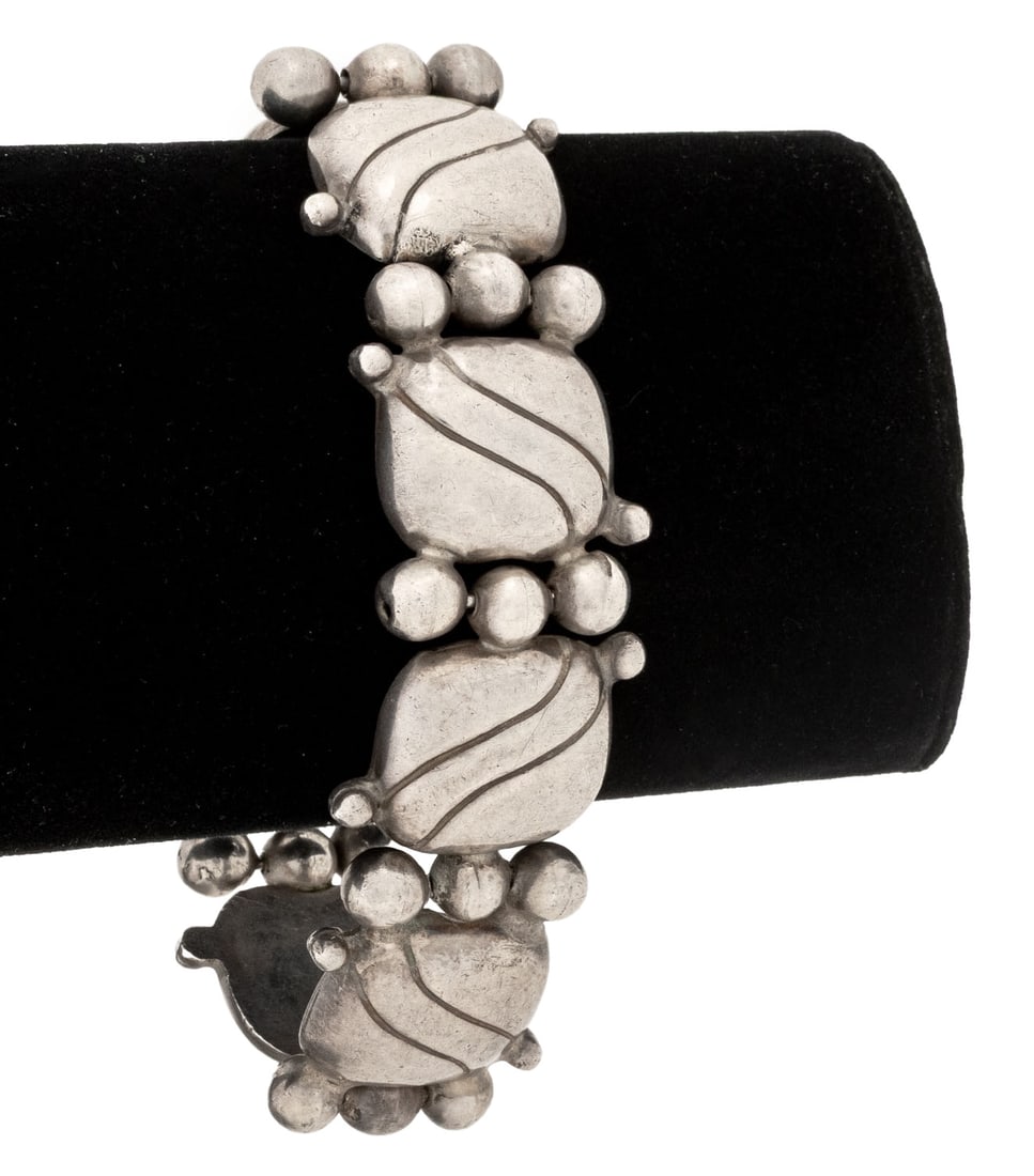 William Spratling Sterling Silver Pillow Bracelet: William Spratling Sterling Silver Pillow Bracelet, designed as silver pillow shaped links brightly polished and incised, worn over the wrist with hinge pin and safety chain clasp, marked: "WS logo,