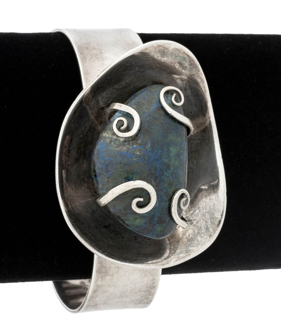 Felipe Martinez Taxco Silver Chrysocolla Bangle: Felipe Martinez Taxco Sterling Silver Chrysocolla Bangle, designed as a hinged bangle, joined with box and tongue clasp, featuring one prong set chrysocolla rough gemstone, weighing approx. 60.00