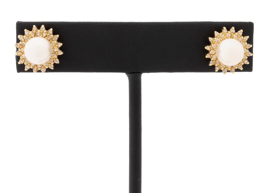 14K Yellow Gold Diamond and Pearl Earrings: Pair of 14K Yellow Gold Diamond and Cultured Pearl Earrings, adorned with two round cultured pearls approx. 7.0 - 7.5 mm., surrounded by sixty four prong set single cut diamonds weighing a total of ap