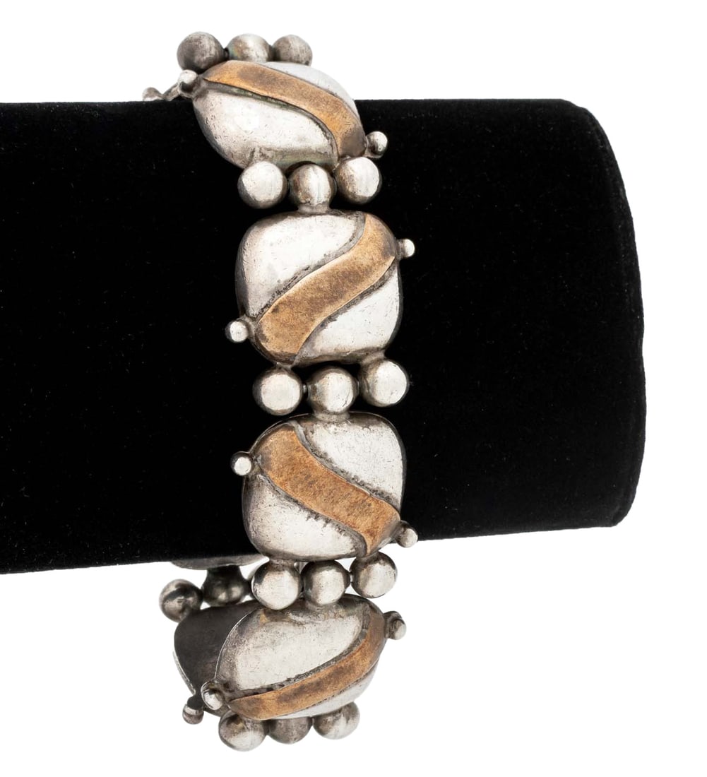 William Spratling Sterling Silver Copper Bracelet: William Spratling Sterling Silver and Copper Bracelet, designed as silver pillow shaped links decorated with copper, worn over the wrist with hinge pin and safety chain clasp, marked: "WS logo,
