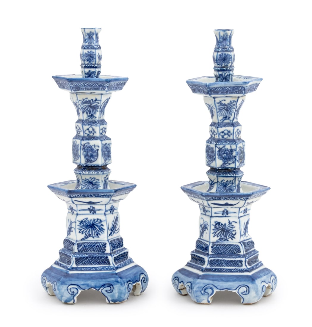 Chinese Blue & White Porcelain Candlesticks, Pair: Pair of Chinese Blue and White Porcelain Hexagonal Candlesticks, each with two tiers of drip pans, floral and geometric design on six scroll form feet, unmarked. 12" H x 5" W x 4" D. Provenance: From