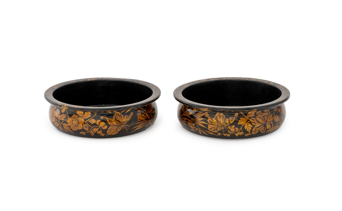 Regency Papier Mache Bottle Coasters, Pair: Pair of Regency Ebonized and Gilt Papier Mache Bottle Coasters, each with scrolling floral and butterfly decoration. 3.5" H x 7" Diameter. Provenance: Property from a Bunny Williams decorated 5th
