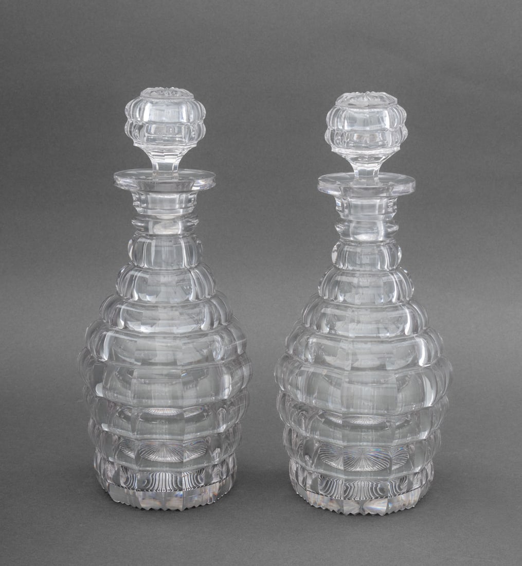 Lobed Cut Crystal Decanters, Pair: Pair of Lobed Heavy Cut Crystal Faceted Decanters. 11.5" H x 5" Diameter. Provenance: From an East 53rd Street Collection. Keywords: Cristal, Stoppered bottles, Barware, Drinkware, Tableware, Hosting,