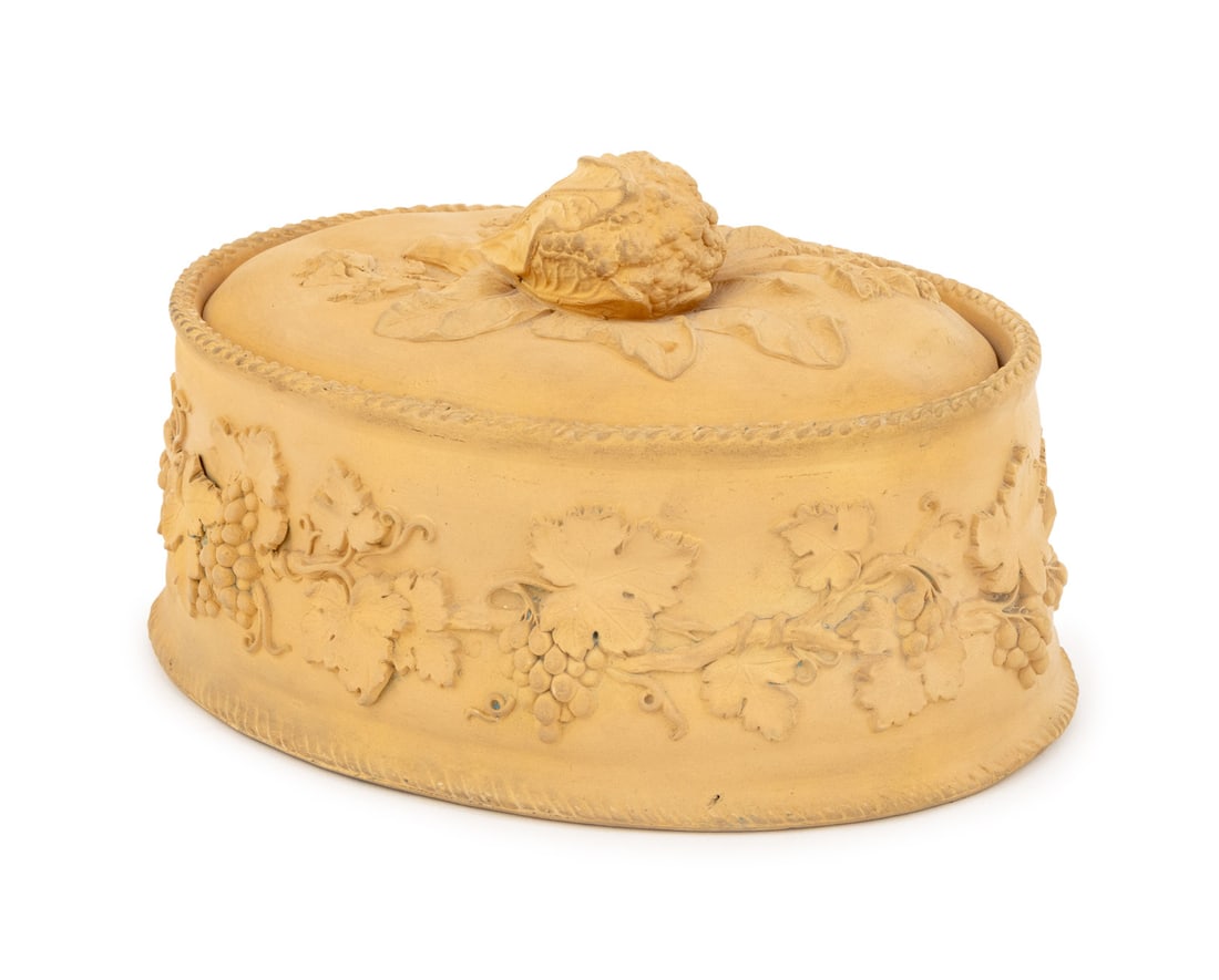 Wedgwood Caneware Covered Game Pie Dish: Wedgwood Caneware Covered Game Pie Oval Dish, the lid with cabbage knop opening to porcelain liner and the body with grapevine motif, marked "Wedgwood" to the underside. 5" H x 9" W x 6.5" D. Provenan