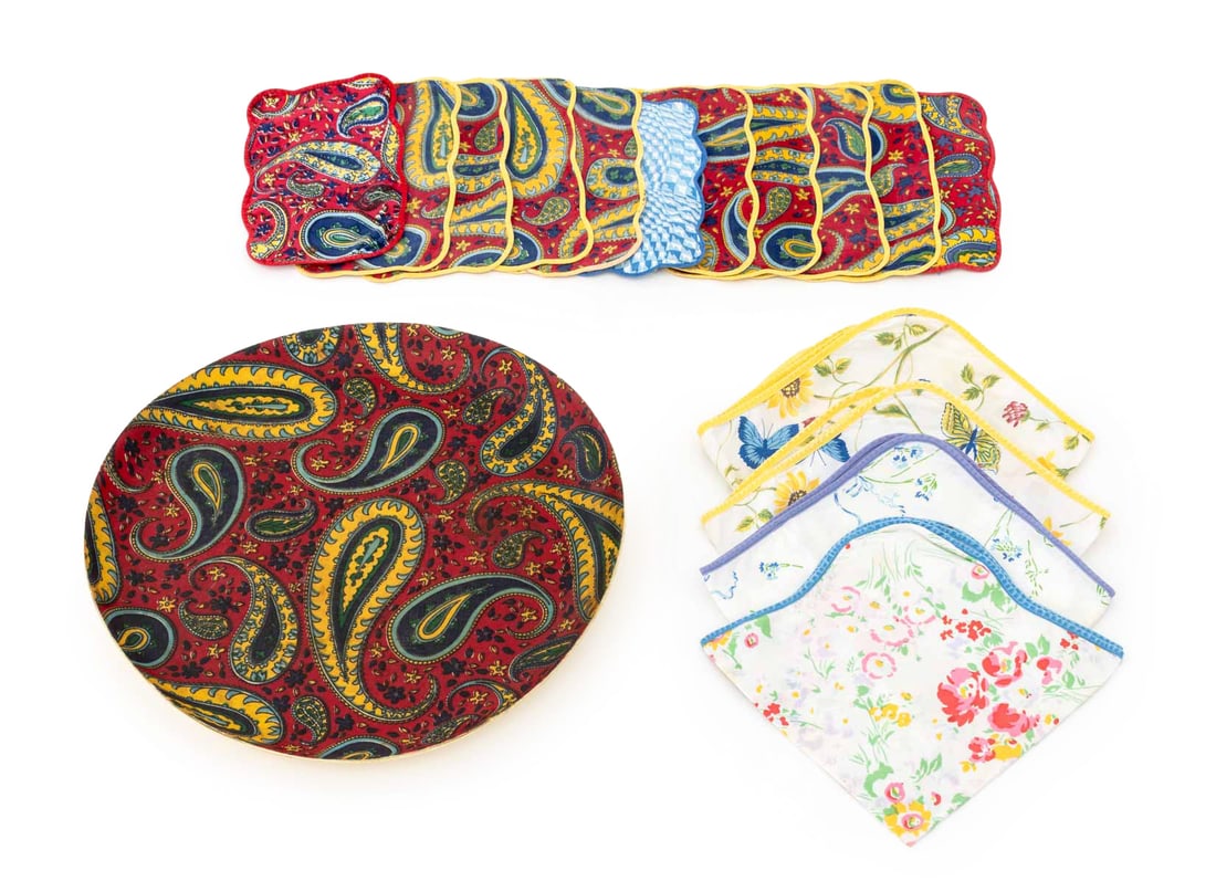 D. Porthault Table Linens & Charger, 16 Pcs.: Collection of D. Porthault Table Linens and Red Paisley Print Charger, with ten (10) matching cocktail napkins, one (1) blue abstract print cocktail napkin, and four (4) table napkins with floral and