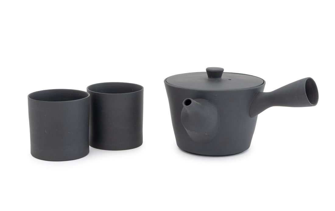 Nankei Pottery Tea Service, 3 Pcs.: Set of Three Nankei Pottery Tea Service Pieces, in matte black, comprising: Kyusu teapot and two tea cups, unmarked. 3.75" H x 8" W x 6.75" D. Provenance: From an East 53rd Street Collection.