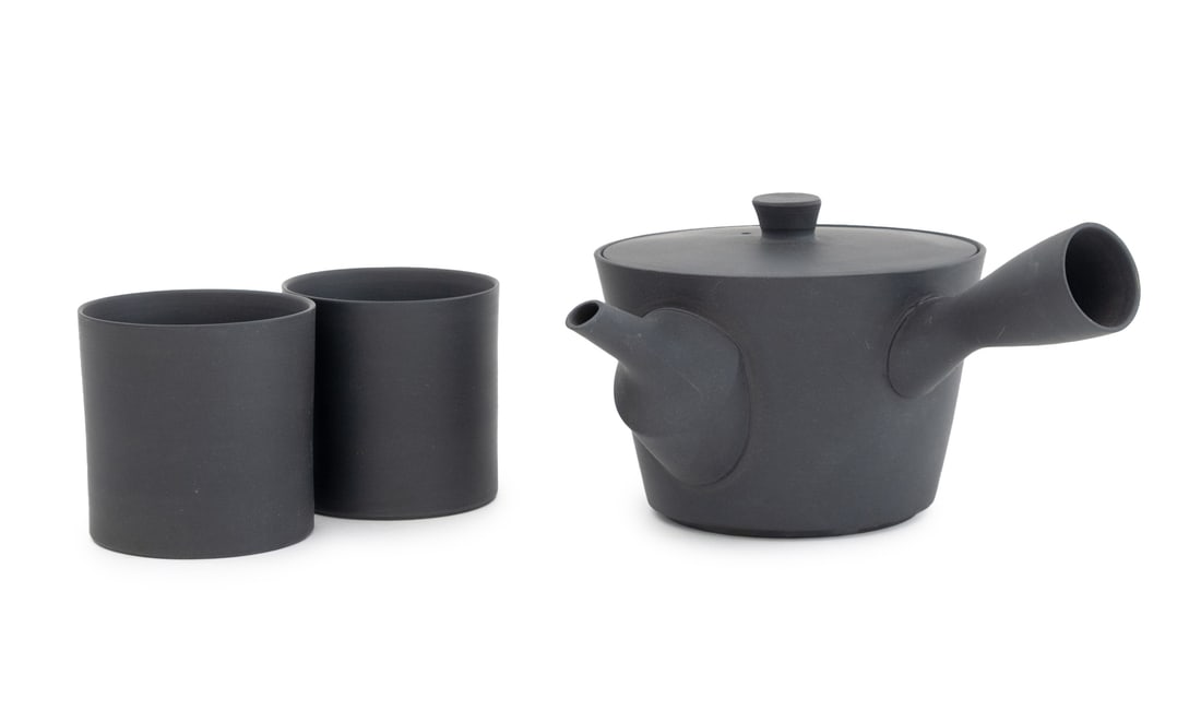 Nankei Pottery Tea Service, 3 Pcs.: Set of Three Nankei Pottery Tea Service Pieces, in matte black, comprising: Kyusu teapot and two tea cups, unmarked. 3.75" H x 8" W x 6.75" D. Provenance: From an East 53rd Street Collection.