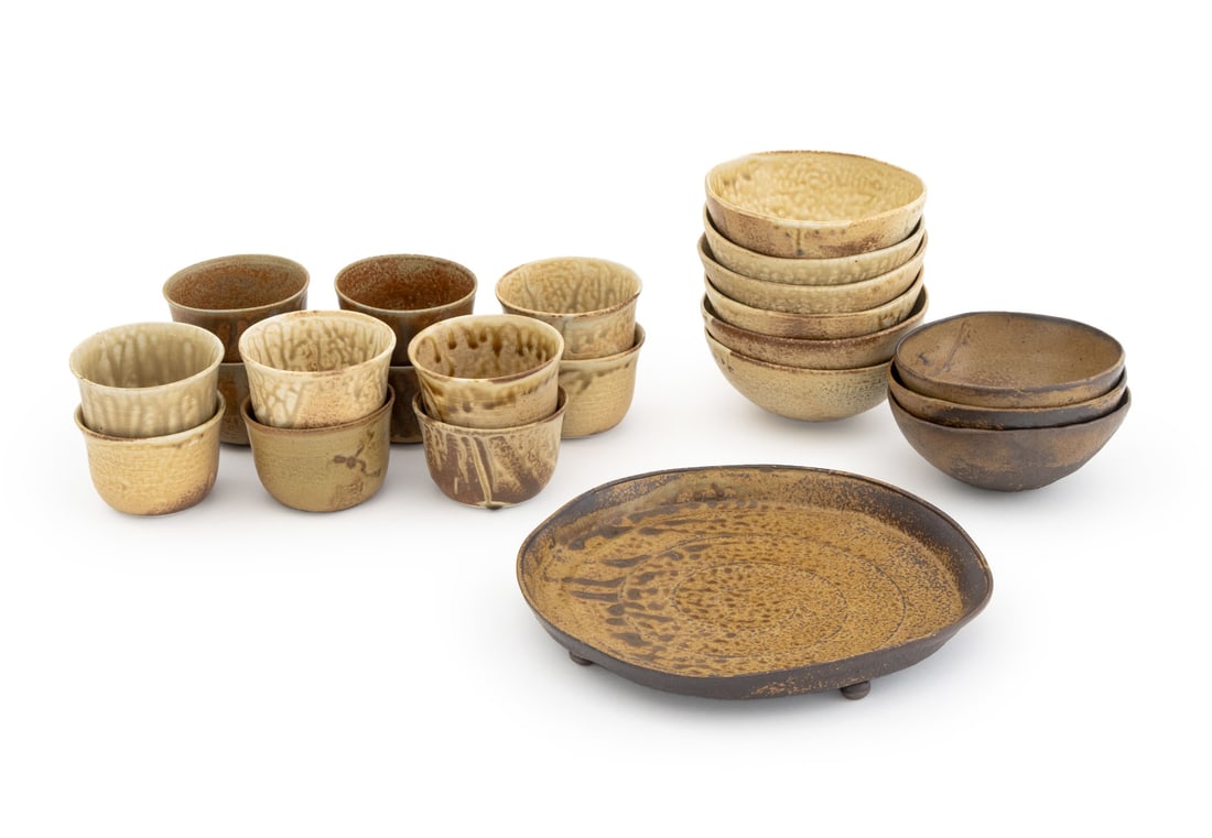 Japanese Signed Glazed Pottery Tableware, 22 Pcs.: Group of 22 Japanese Glazed Pottery Tableware Pieces, comprising: (5) five teacups in dark glaze, (7) seven teacups in beige glaze, (3) three bowls in dark glaze, (6) six bowls in beige glaze, and