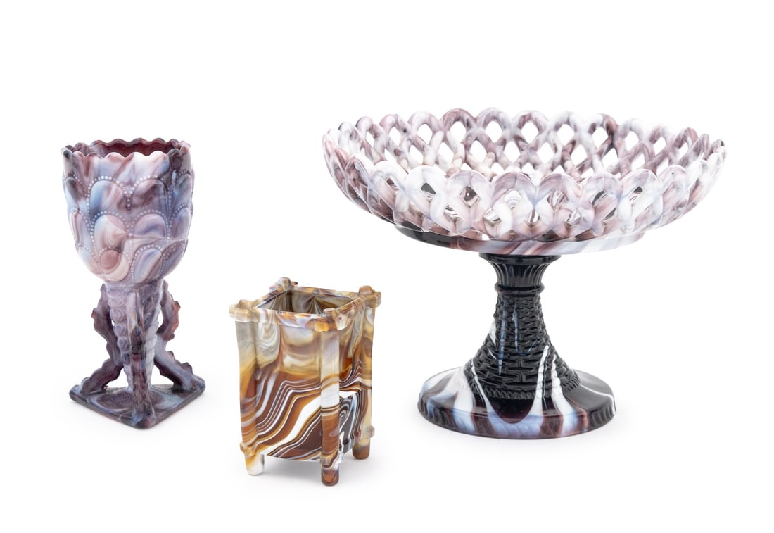 Challinor Taylor Co. Slag Glass Tableware, 3 Pcs: Group of Three Challinor Taylor Co. Slag Glass Tableware Pieces, 19th century, comprising: purple pierced lattice footed compote, purple chalice the cup with scalloped rim on three hoof form legs