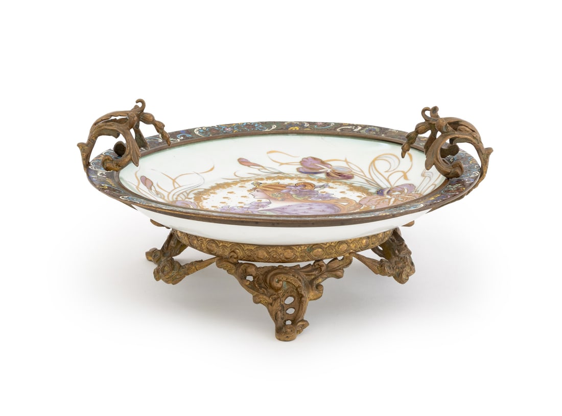 Art Nouveau Sevres Porcelain Plate: Art Nouveau Sevres Porcelain Plate, with enamel scroll and floral rim with red-haired beauty and lilies painted to center mounted on bronze base with floral form handles and three scroll form feet. Ov