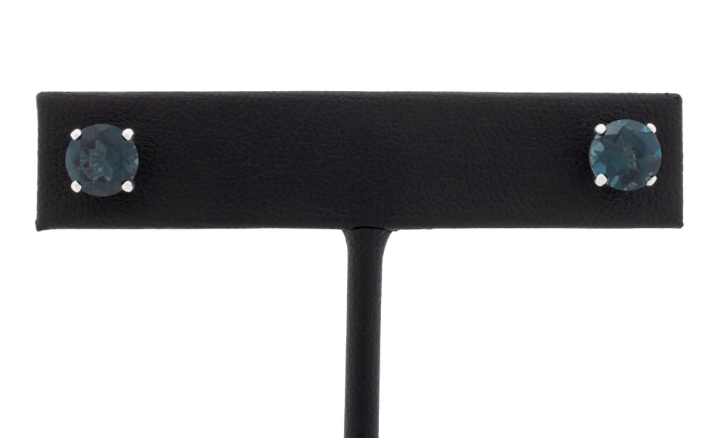 14K White Gold Blue Topaz Stud Earrings: Pair of 14K White Gold Blue Topaz Prong Set Stud Earrings, marked: "14K" with maker's mark. 5/8" x 1/4"; width: 7.00mm approx.; total weight: 1.1 dwt. approx. Provenance: From a New Jersey