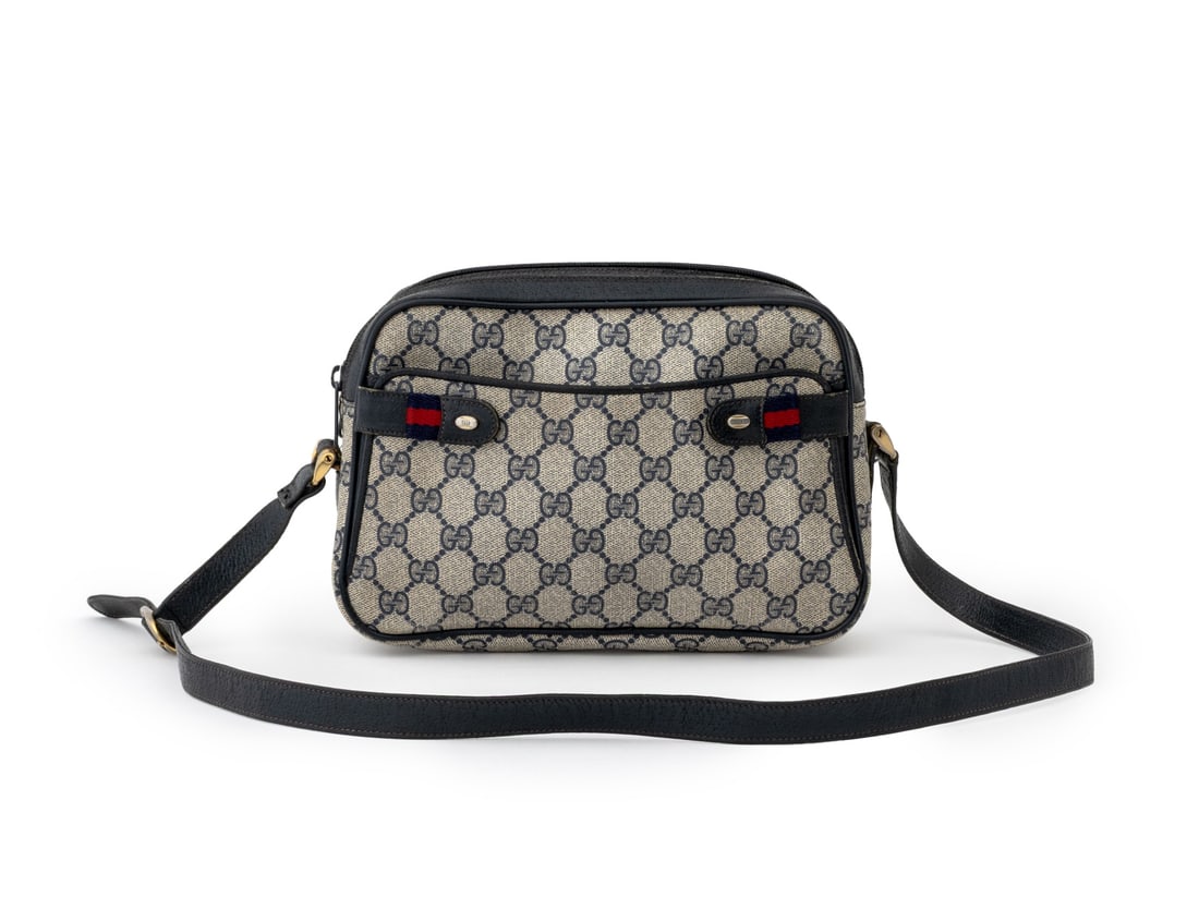 Gucci Monogram Waxed Canvas Handbag: Gucci Monogram Waxed Canvas Handbag, with "Gucci Accessory Collection / Made in Italy" label inside and blue leather trim and crossbody strap. Without strap: 6.75" H x 9.75" W x 3" D. Provenance: From