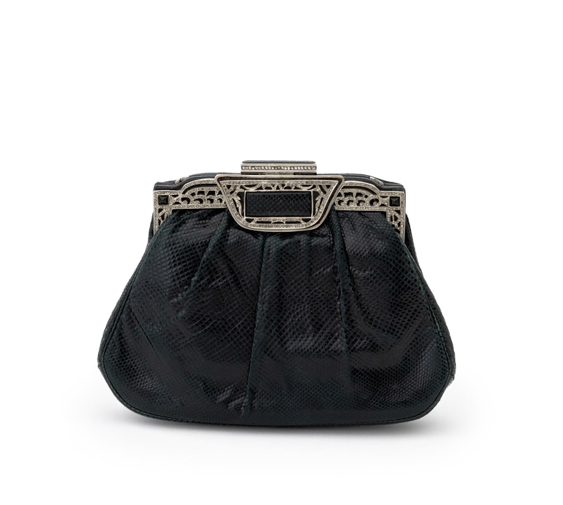 Judith Leiber Karung Leather Handbag: Judith Leiber Black Karung Snakeskin Leather Handbag, plaque label inside, with optional shoulder strap, pocket mirror, comb, and original dustbag. 6.25" H x 8" W x 1.75" D. Provenance: From the Colle