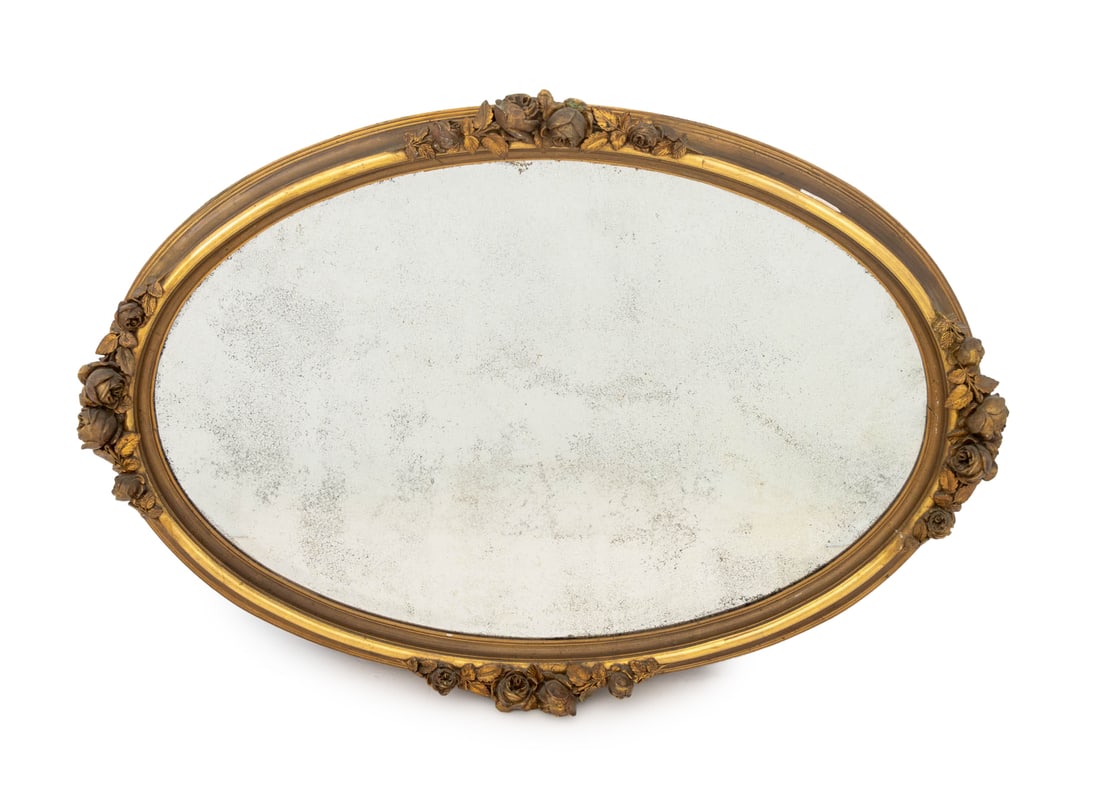 Gilded Age Gilt Composition Oval Beveled Mirror: Gilded Age Rose Motif Gilt Composition Oval Beveled Glass Mirror. Mirror plate: 25.5" H x 39.5" W; 33" H x 47" W x 5" D. Provenance: From a New York City Collection. Keywords: Belle Epoque, Overmantel