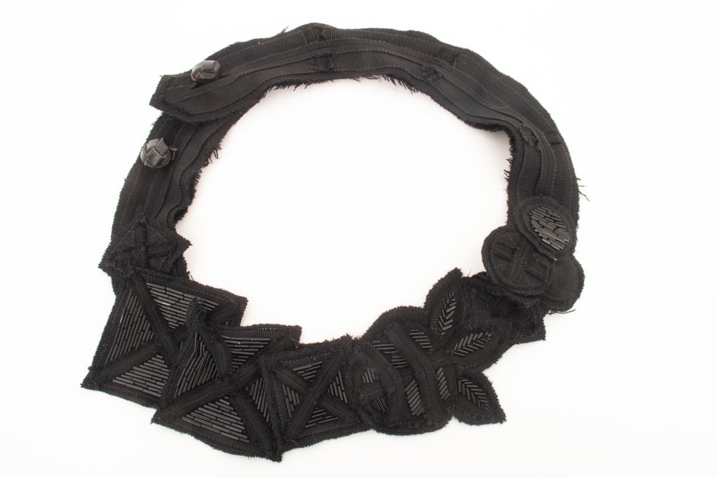 Prada Black Beaded Cotton Statement Necklace: Prada Black Beaded Cotton Statement Necklace, with knotted leather double button closure, labeled "Prada" to reverse. 19.5" L (open). Provenance: From a New York City Collection. Keywords: Designer, F