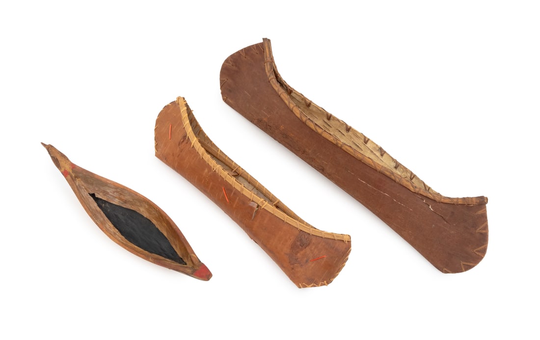 Native American Canoe Models, 3: Collection of Three Native American Canoe Models, comprising: two Ojibwe birch bark canoes and a Quinault polychrome painted and hand-carved wood canoe with eagle head prow, marked "Quinault Indian Ca