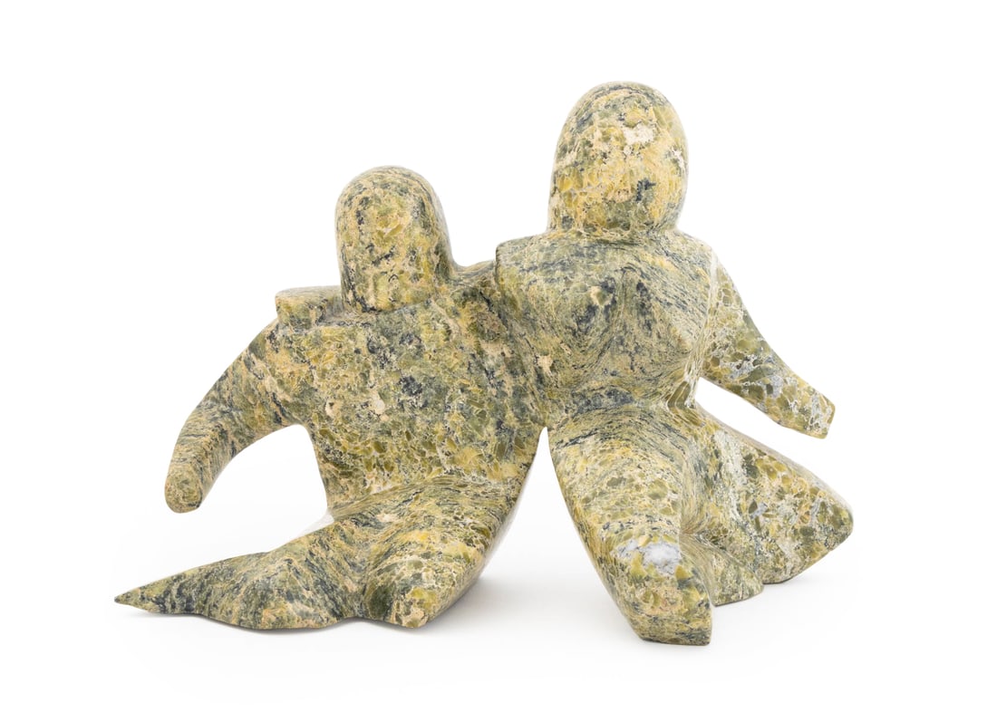 Inuit Carved Serpentine Seated Figures Sculpture: Inuit Carved Serpentine Seated Figures Sculpture, with "Canada / eskimo art esquimau" label to underside. 6.5" H x 9.5" W x 4.5" D. Provenance: From a Park Slope Estate. Keywords: Eskimo Art,