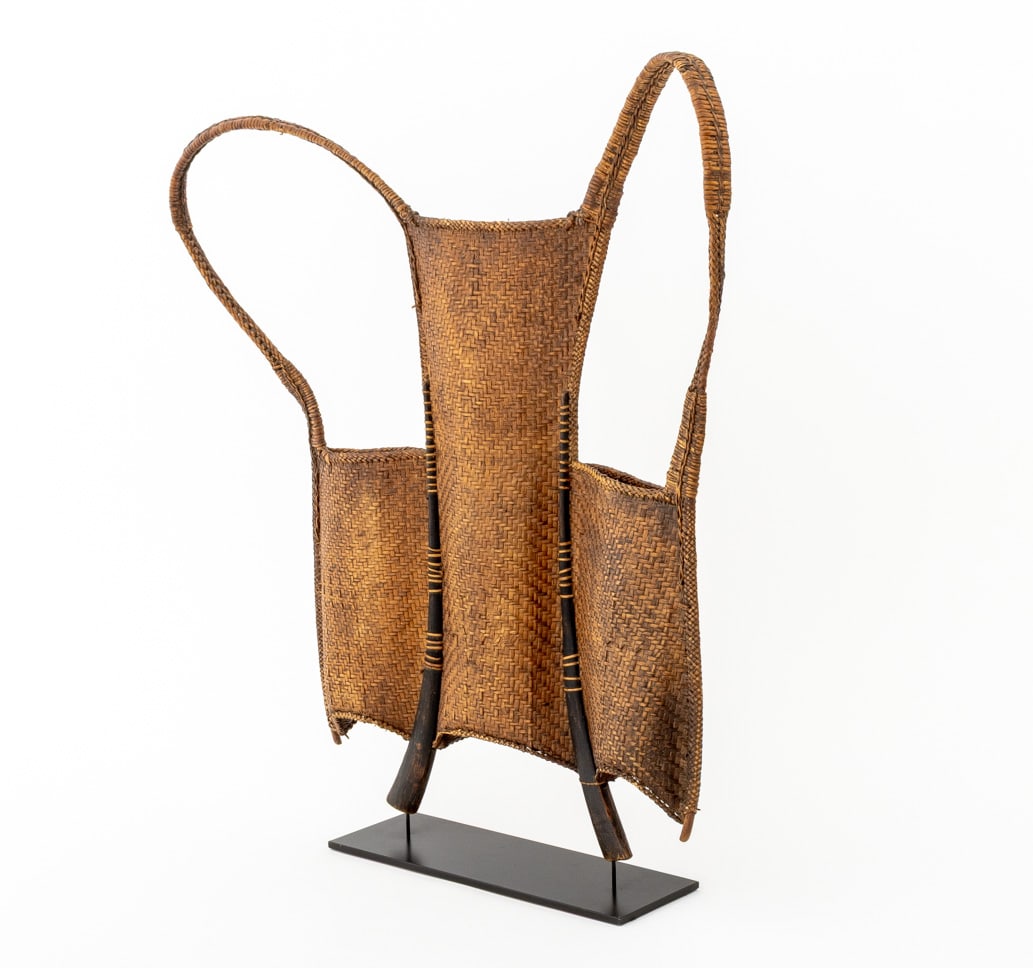 Vietnamese Woven Rattan Hunter Backpack: Vietnamese Woven Rattan Hunter Backpack, mounted on a black metal stand. Overall: 25.5" H x 22.25" W x 4" D. Provenance: From an East 78th Street, New York Estate. Keywords: Annam, Basketry, Hunting,