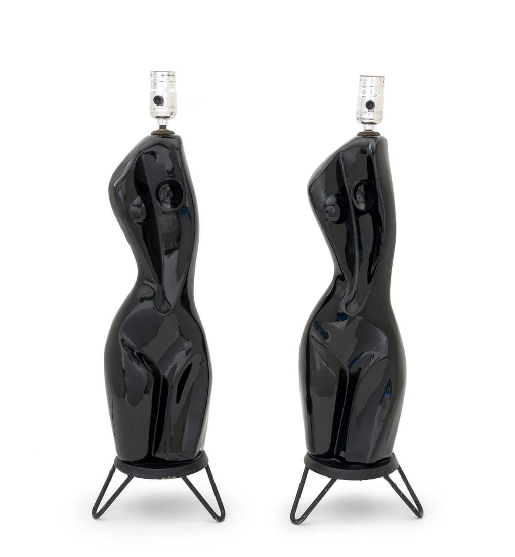 Modernist Female Form Black Ceramic Table Lamps, 2: Pair of Modernist Female Form Black Glazed Ceramic Table Lamps, each on three hairpin legs. 22.75" H x 7" Diameter. Provenance: From a New York City Collection. Keywords: Lighting, Modern design,