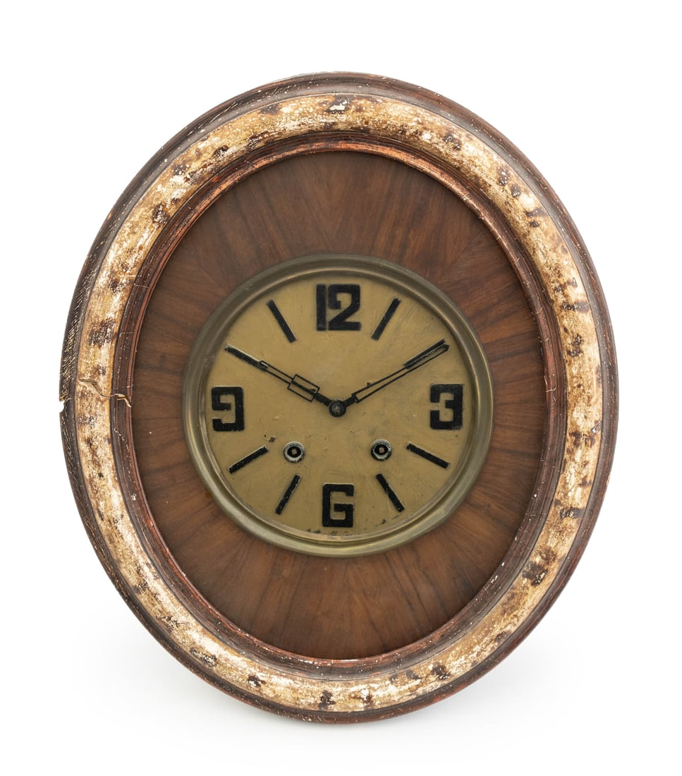 French Art Deco Oval Mahogany and Brass Wall Clock: French Art Deco Oval Mahogany and Brass Wall Clock, the brass face with Arabic numerals and dash indices, surround by ebonized wood and glass case. 23" H x 19" W x 6" D. Provenance: From a New York Ci
